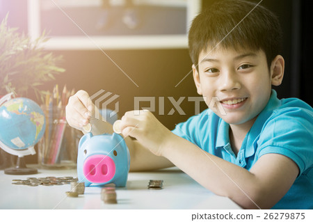Little asian boy insert coin into piggy bank 26279875
