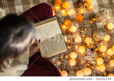 Top view of young woman at home reading book 26282144