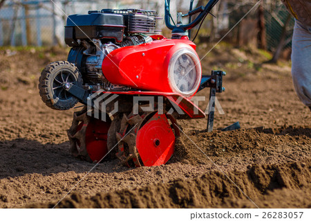 Man working in the garden with Garden Tiller 26283057