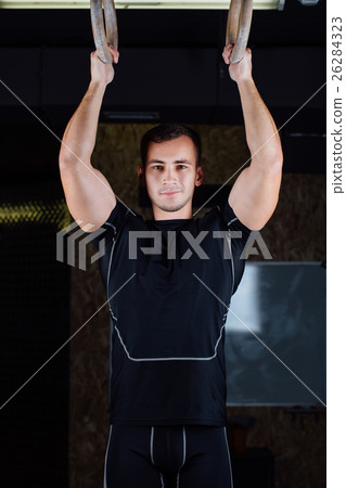 man using gymnastic rings man using gymnastic rings 26284323
