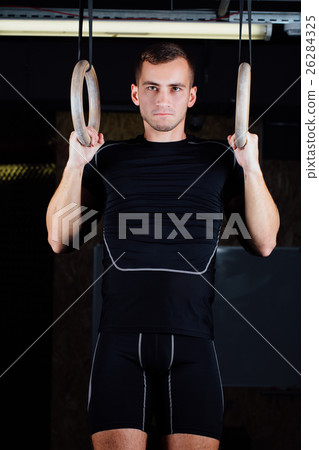 man using gymnastic rings man using gymnastic rings 26284325