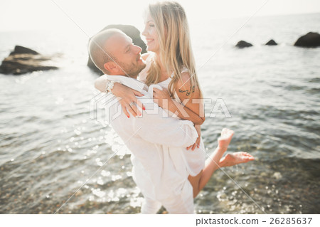 Fashion model couple with tattoo posing outside Fashion model couple with tattoo posing outside 26285637