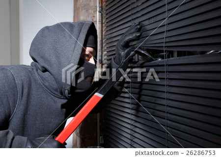 Thief trying to open window 26286753