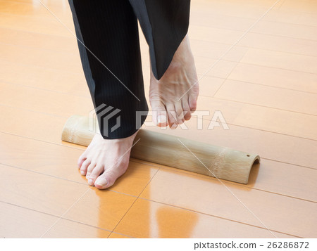 A man with a pain in stepping on a bamboo 26286872