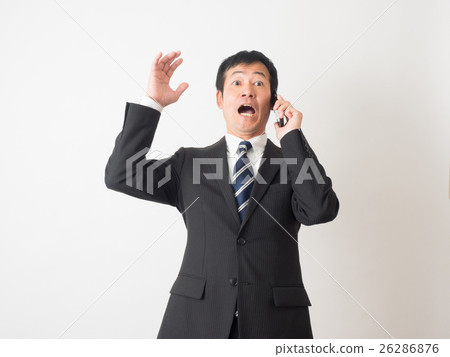 Middle businessman surprised to talk on mobile phone 26286876