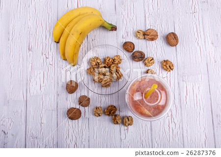 red detox coctail with bananas on walnut lies red detox coctail with bananas on walnut lies 26287376