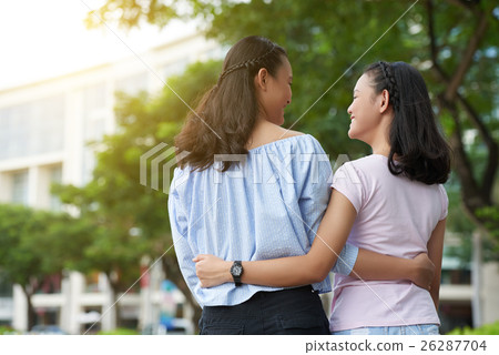 Hugging sisters 26287704