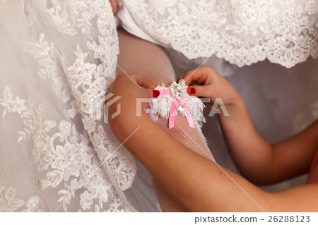 The bridesmaid helps to bride The bridesmaid helps to bride 26288123