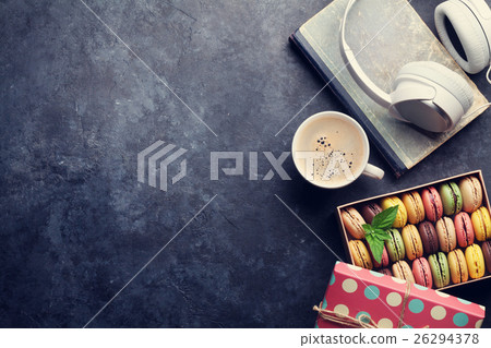 Colorful macaroons in a gift box and headphones Colorful macaroons in a gift box and headphones 26294378