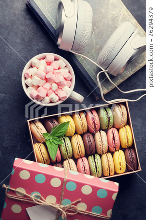 Colorful macaroons in a gift box and headphones Colorful macaroons in a gift box and headphones 26294379