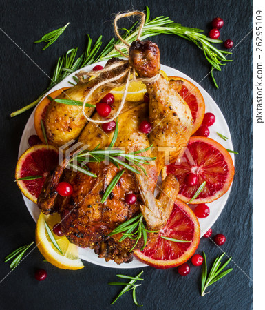 Roasted whole chicken on white plate on stone Roasted whole chicken on white plate on stone 26295109