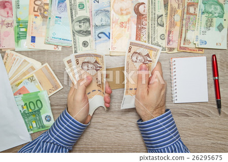Banker counting Convertible mark at his office tab Banker counting Convertible mark at his office tab 26295675