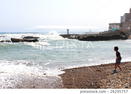 A boy watching the stormy sea 26295757