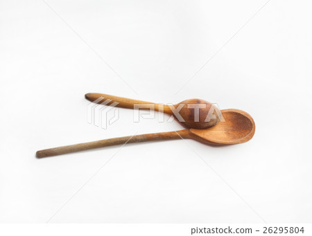Two wooden spoons isolated on white background Two wooden spoons isolated on white background 26295804