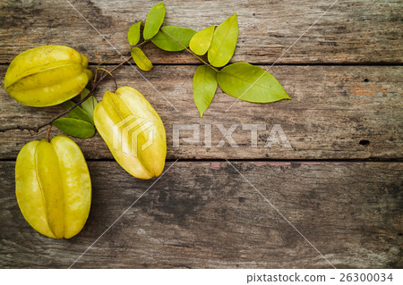 green fruit with leaves on the wooden table 26300034
