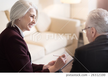 Happy businesswoman discussing the topic with her 26312100