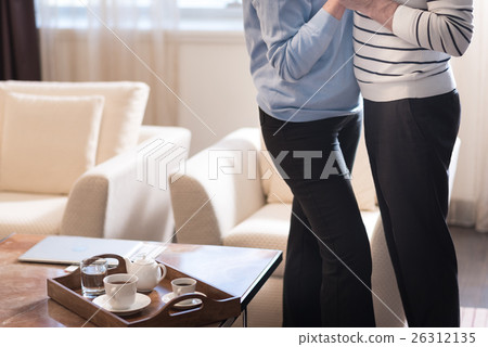 Aged couple standing near the at home Aged couple standing near the at home 26312135