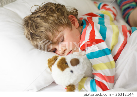 little blond kid boy in colorful nightwear clothes 26312144