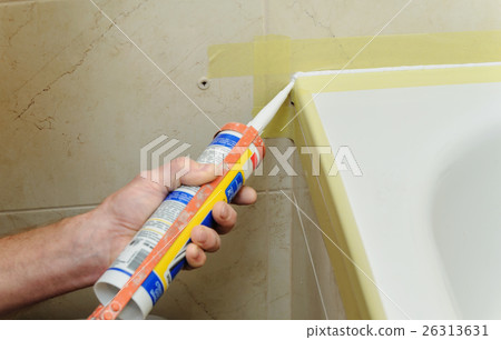 Worker puts silicone sealant. Worker puts silicone sealant. 26313631