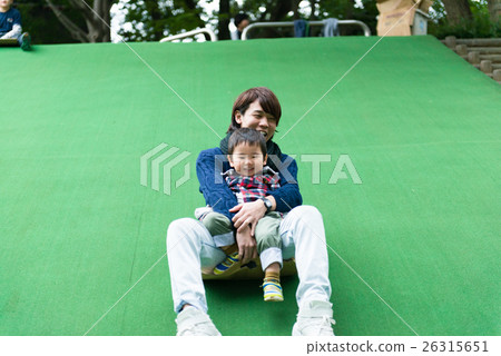 Parents and children on a cardboard slide Parents and children on a cardboard slide 26315651