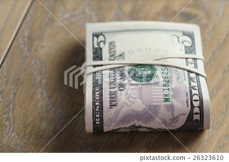 bunch of dollars on oak wood table bunch of dollars on oak wood table 26323610