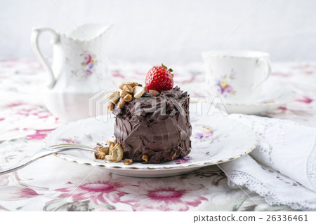 Chocolate Torte with Nuts and Strawberry on Plate 26336461