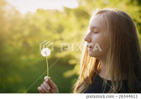 teen girl ready to blow dandelion 26344611