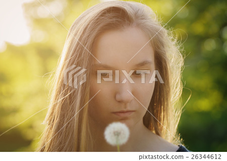teen girl ready to blow dandelion to the camera teen girl ready to blow dandelion to the camera 26344612
