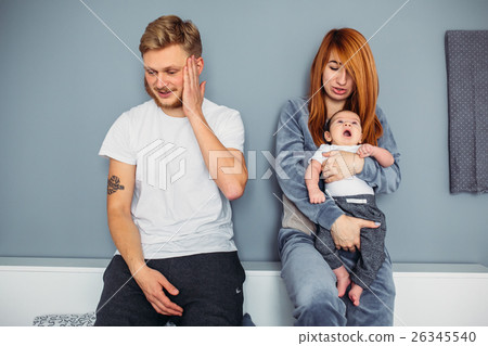 Young family with a baby by the wall Young family with a baby by the wall 26345540