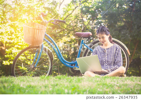 woman sit on lawn with using work laptop woman sit on lawn with using work laptop 26347935