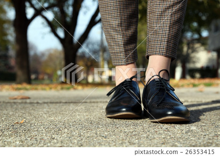 woman in trousers going in a classic fashion boots 26353415