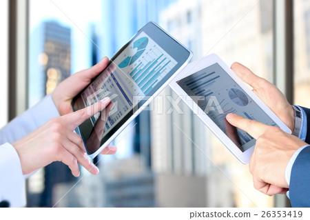 Colleagues working and analyzing financial figures 26353419