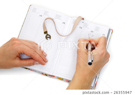 Notebook opened with female hands writing Notebook opened with female hands writing 26355947