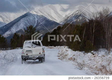 Car goes on the snow-covered road in Trans-Baikal Car goes on the snow-covered road in Trans-Baikal 26356739