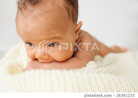 Newborn baby laying stomach down on bed 26361153
