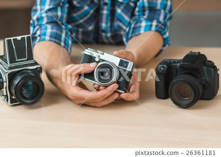 Unrecognizable man shows simple film camera Unrecognizable man shows simple film camera 26361181