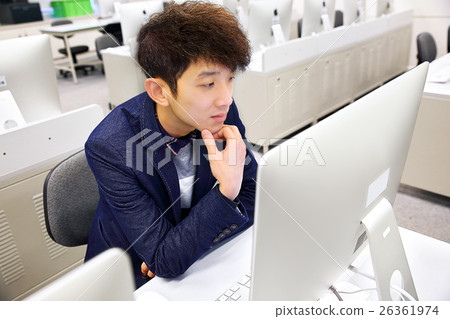 young man using computer in classroom 26361974