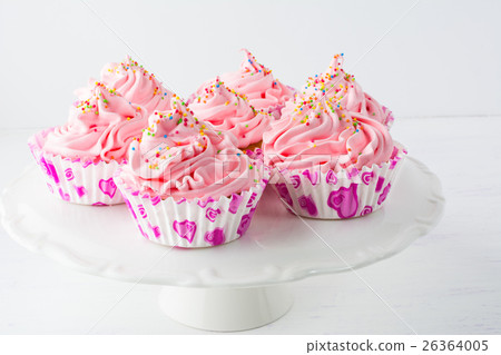 Decorated pink birthday cupcakes on the cake stand 26364005