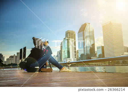 Woman taking photo and sitting in public park Woman taking photo and sitting in public park 26366214