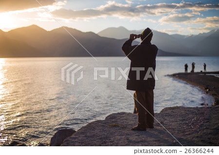 Rear view of Indian man taking photo at Pangong Rear view of Indian man taking photo at Pangong 26366244