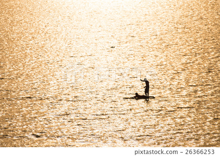 Silhouette of a couple on a boat in the sea Silhouette of a couple on a boat in the sea 26366253