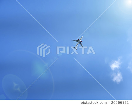 Flying plane in blue sky with sunray Flying plane in blue sky with sunray 26366521