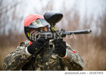 Paintball sport player wearing protective mask and aiming gun Paintball sport player wearing protective mask and aiming gun 26367945