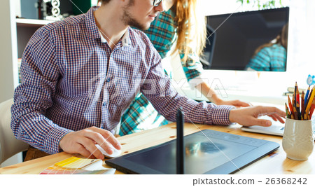 Young woman and man working from home office 26368242