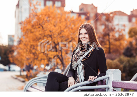Young woman sitting at the bench 26368977