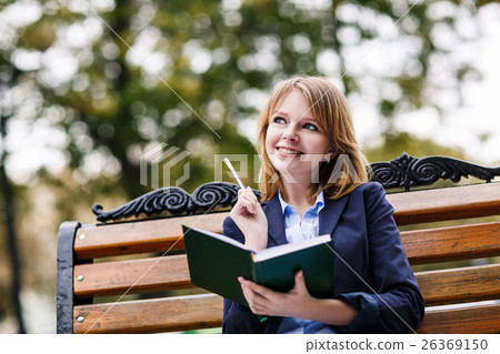 Woman sitting on the bench with diary 26369150