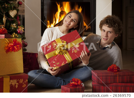 Young couple celebrating Christmas holidays Young couple celebrating Christmas holidays 26369570