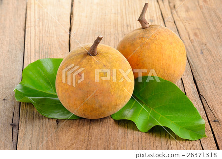 Santol fruit  on wooden  background 26371318