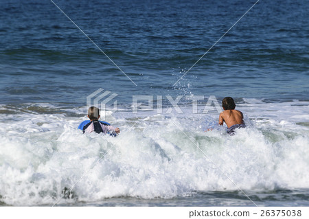 Surfer boy heading for big wave Surfer boy heading for big wave 26375038