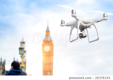 Hovering drone taking pictures of Big Ben in 26376145